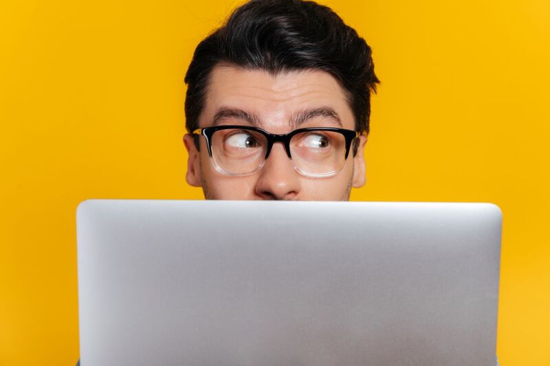 Un homme surveille son ordinateur pour profiter des promotions sur les box internet