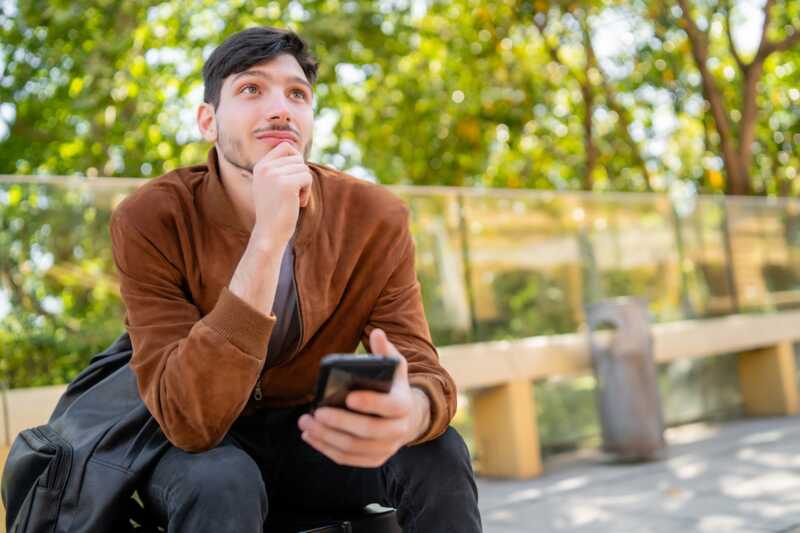 homme réfléchit avec son smartphone